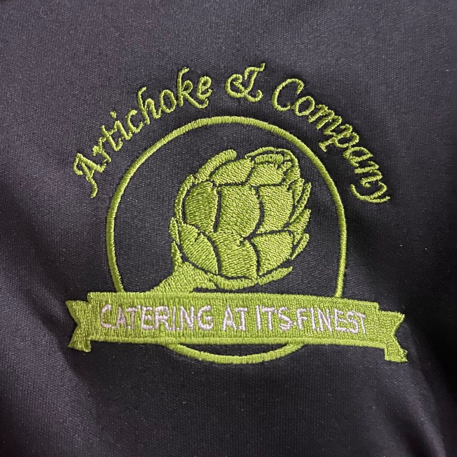 Artichoke & Company catering logo embroidered on a black shirt