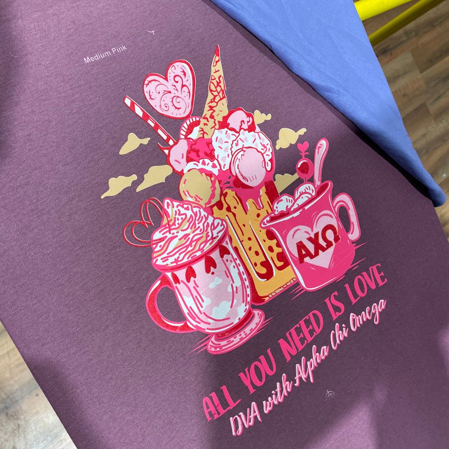 Purple tee with a colorful milkshake 'All you need is love' design