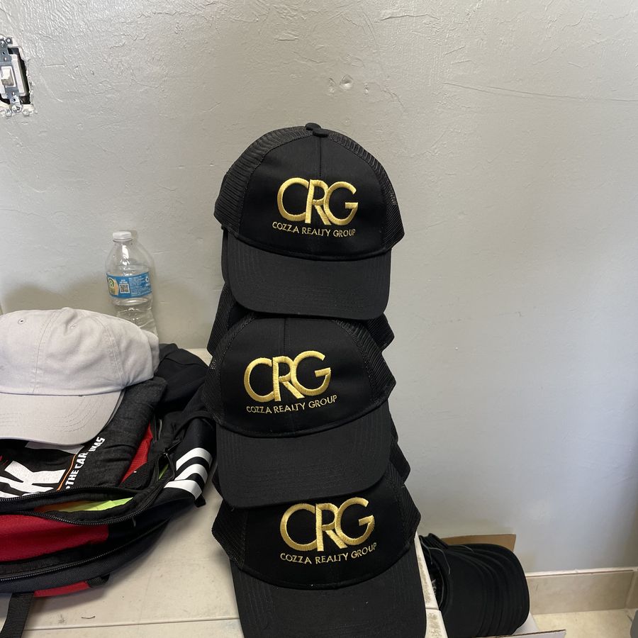Black caps embroidered with a gold CRG logo