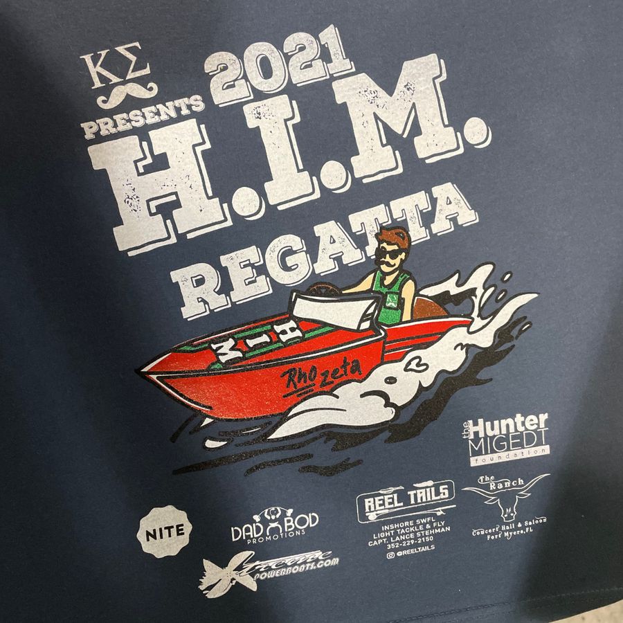 Navy tee with a multi-color 2021 H.I.M. Regatta print and sponsor logos