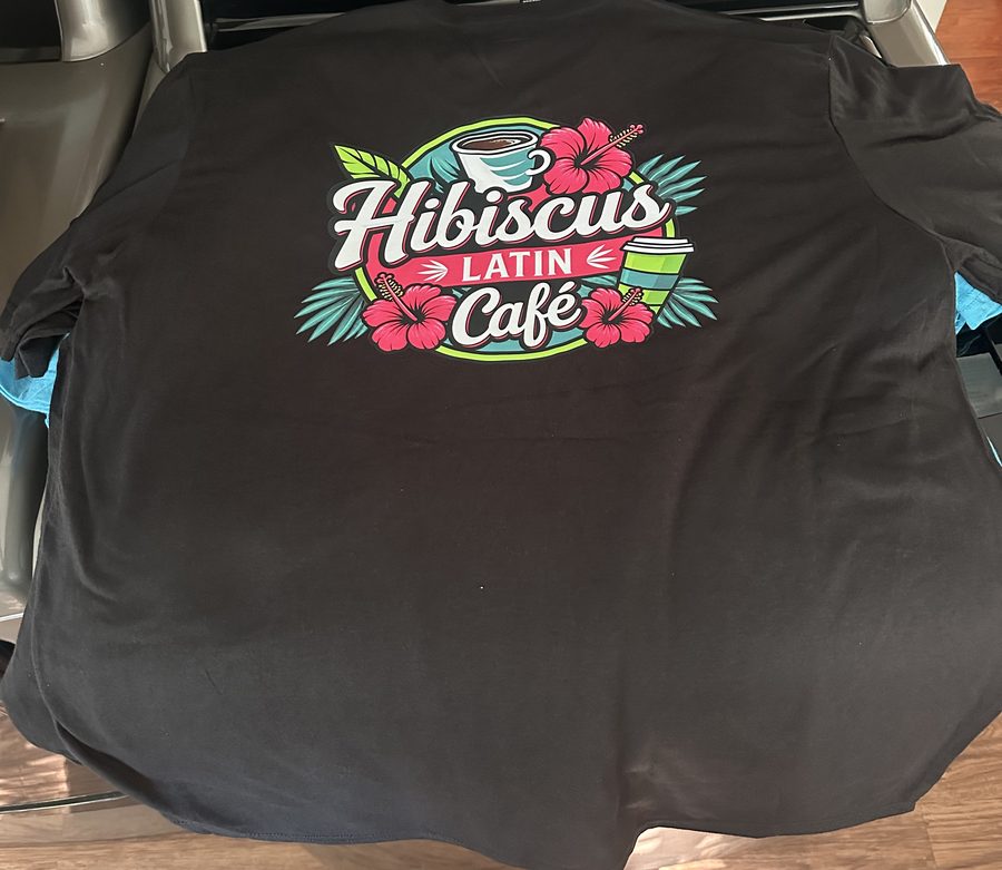 Black tee with a colorful tropical cafe logo