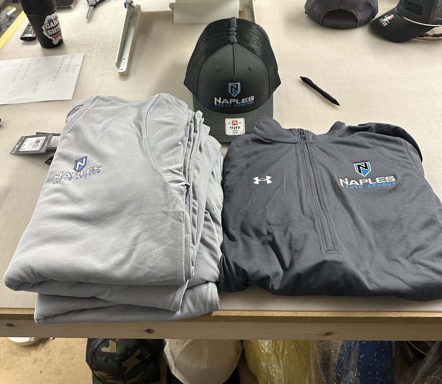 Crew kit with an embroidered quarter-zip, a hat and printed tees