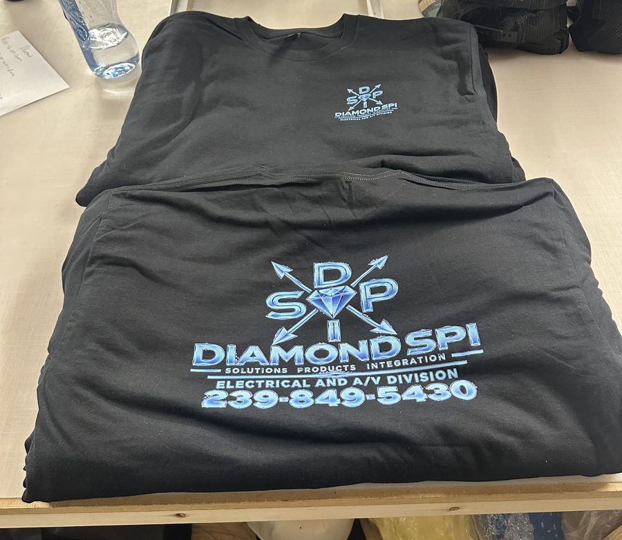 Black tees with a small front logo and a large blue back print